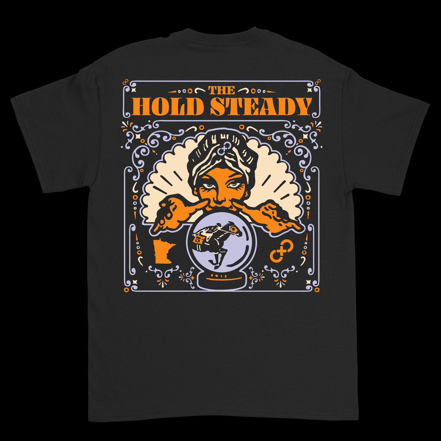 The Hold Steady black T-shirt features a fortune teller with a crystal ball, bold orange band name above, and purple, orange, and white decorative patterns.