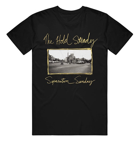 The Hold Steady Comfort Colors black T-shirt features handwritten-style "The Hold Steady" and "Separation Sunday" text above a black-and-white city street scene framed in gold—ideal for fans of unique band merch.