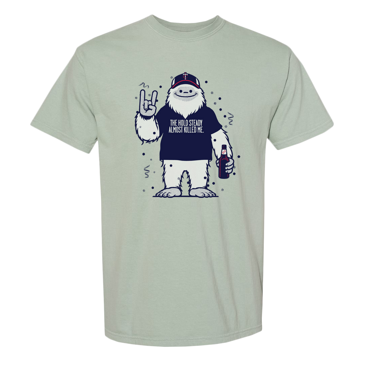 A light gray The Hold Steady Comfort Colors T-shirt in soft ring-spun cotton shows a cartoon yeti in a cap, holding a drink, flashing a rock gesture, with the text: THE HOLIDAYS ALMOST KILLED ME.