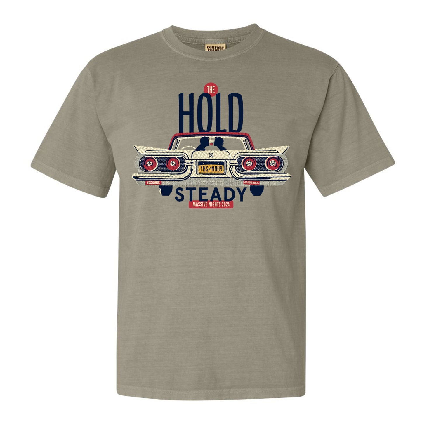 The Hold Steady khaki olive t-shirt with a classic car’s rear graphic, The Hold Steady text above, Massive Nights 2018 below, and license plate THS-NYCS. Ideal vintage-inspired shirt for fans of this iconic event.
