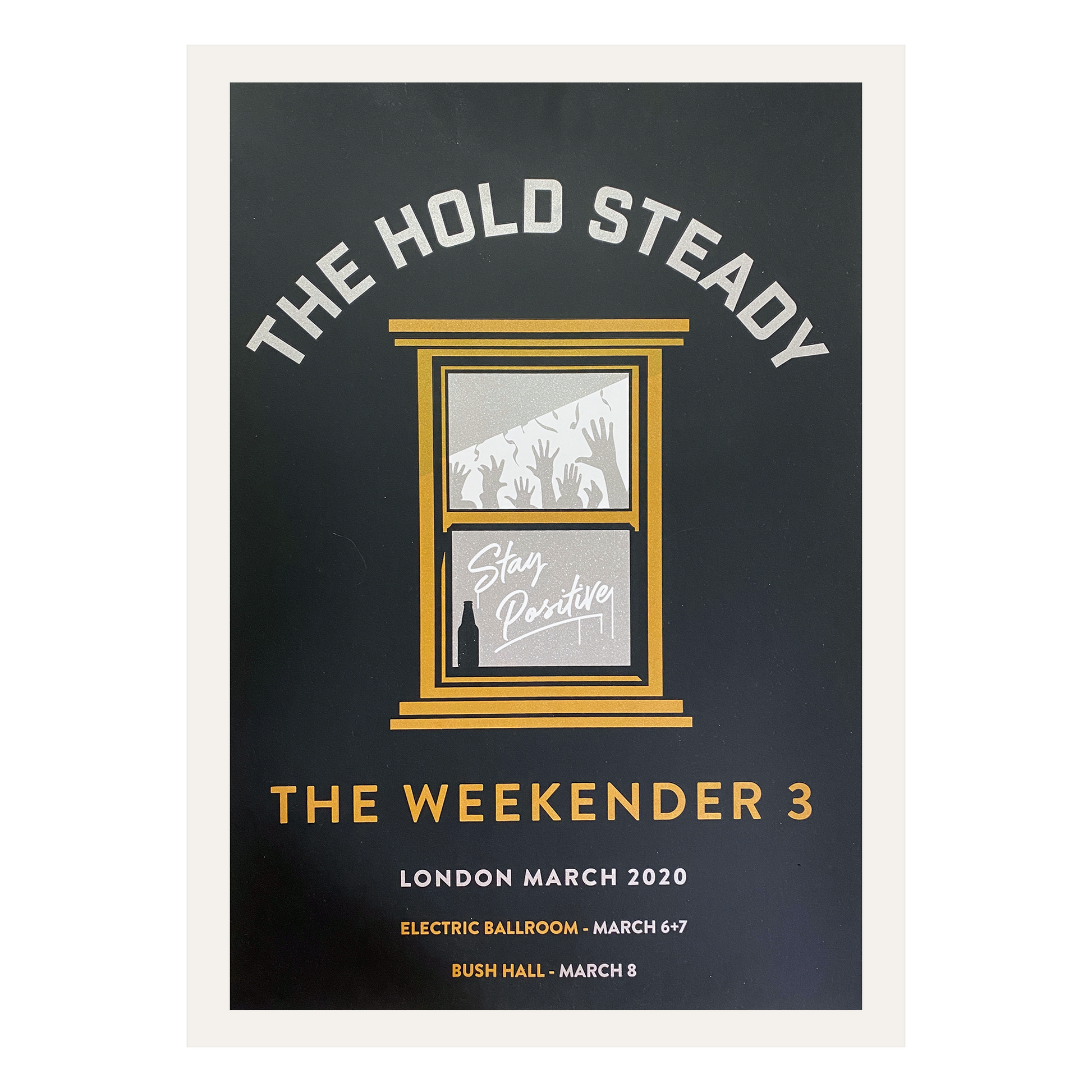 Limited edition screen printed poster from The Hold Steady for The Weekender 3 in London, March 2020. Showcases a window with "Stay Positive," silhouettes of raised hands, and event details for Electric Ballroom and Bush Hall. Ideal for collectors—ships securely rolled in a poster tube.